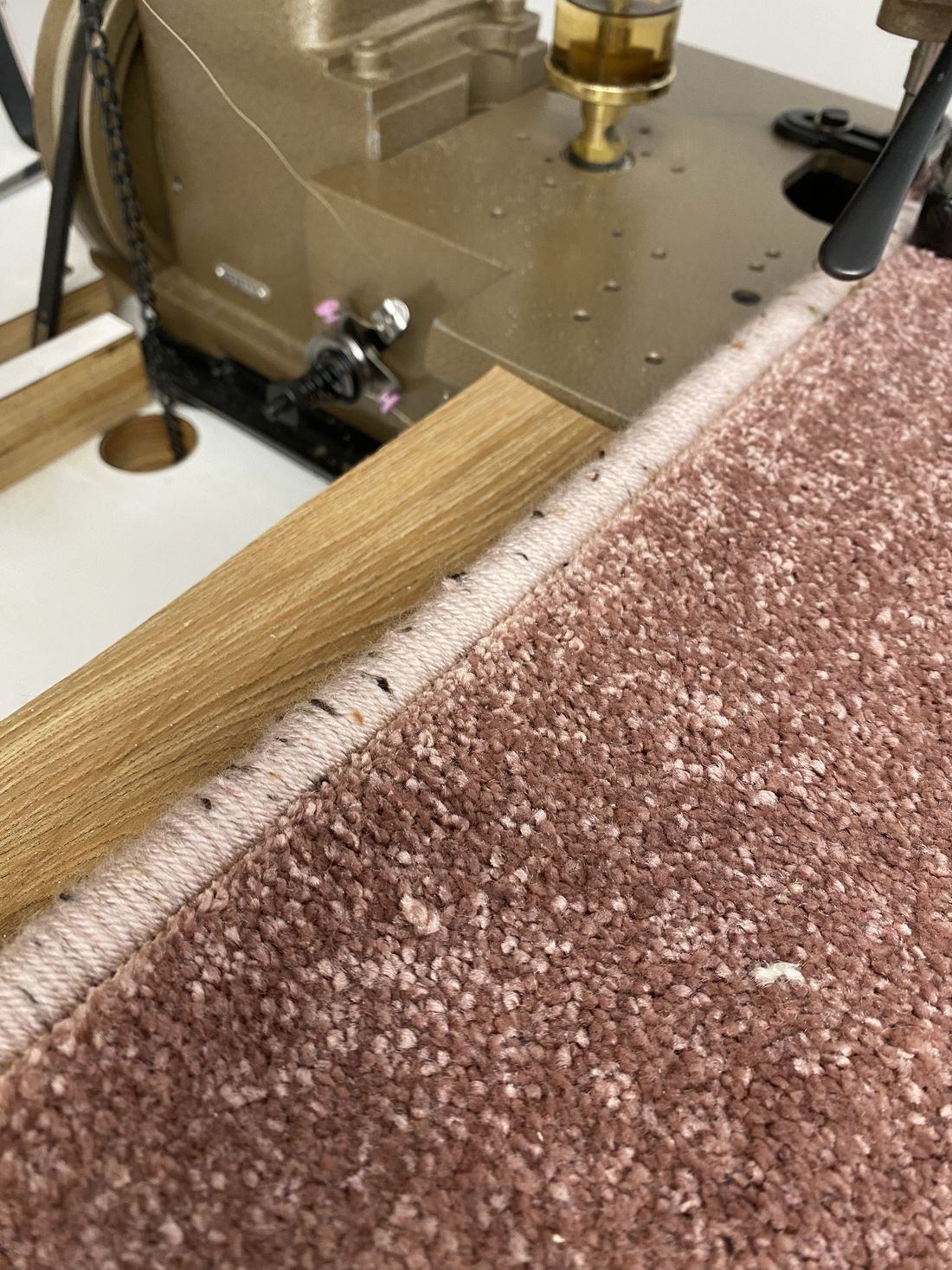 Close-up of a whipped edge being finished on the machine